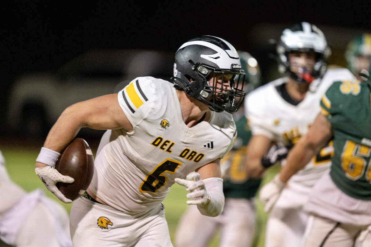The Del Oro Golden Eagles' Landen Parry (6) runs through the Placer Hillman defense on Friday.