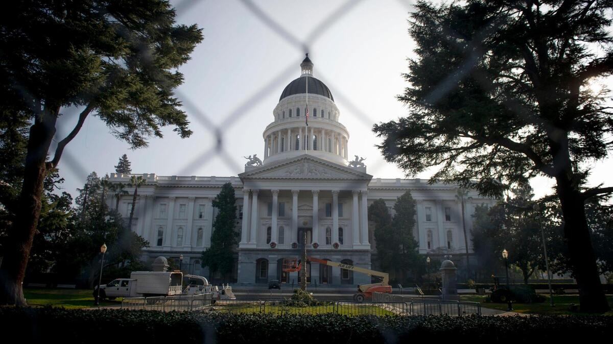 The California Capitol stands behind new fencing that surrounds the building on Friday, Jan. 15, 2020. All 50 states have been warned of possible violent protests at their capitols leading up to Inauguration Day, Wednesday, Jan. 20.