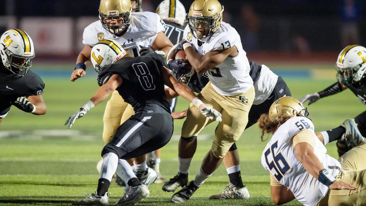 Elk Grove’s Zeke Burnett runs the ball 8 yards for a first down during the first quarter in the game at Lincoln High School in Lincoln on Friday, Sept. 17, 2021. Elk Grove won 49-23.