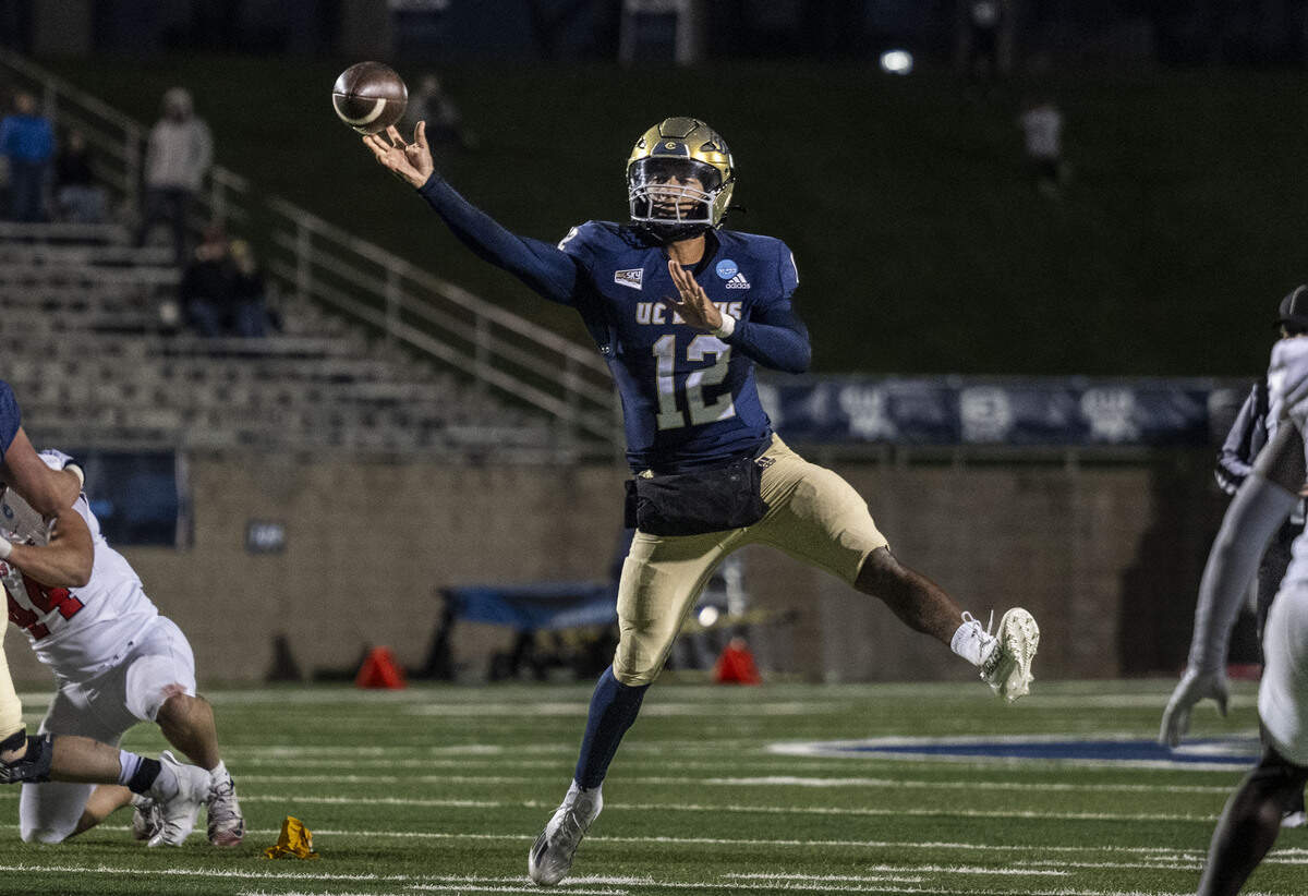 UC Davis Aggies quarterback Caden Pinnick (12) throws a pass in the fourth quarter during a NCAA FCS playoff quarterfinal at UC Davis Health Stadium on Dec. 13.