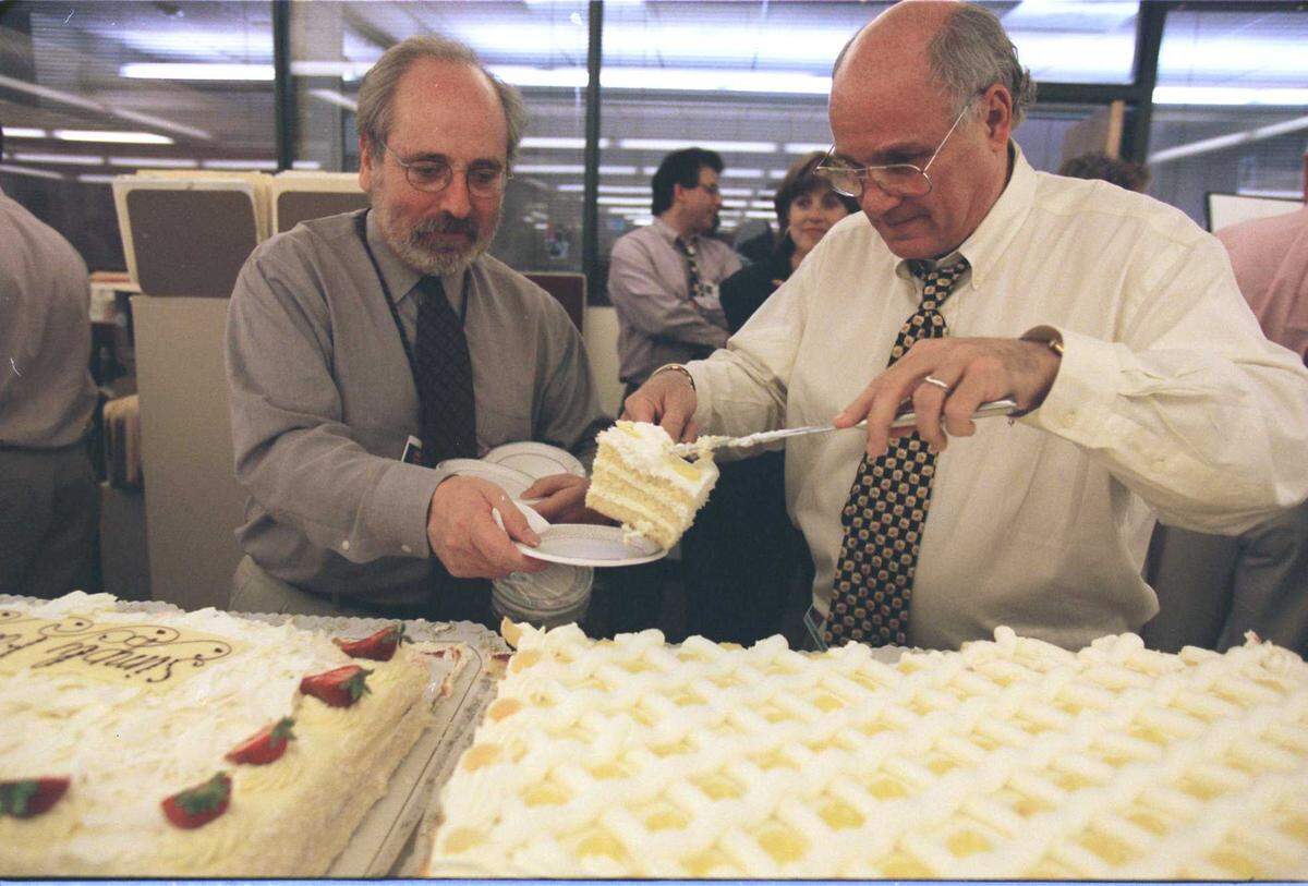 Executive Editor Gregory Favre serves a slice of cake to Mort Saltzman during an office celebration on June 3, 1988, in The Sacramento Bee newsroom. Saltzman, a witty and tough-minded newsroom editor and leader who had an instinct for breaking news, died Wednesday, Nov. 9, 2022, at the age of 82.