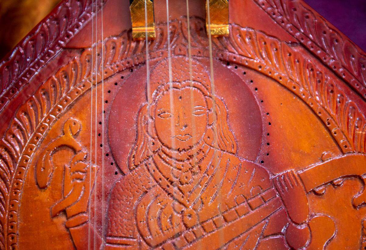 The Hindu goddess Saraswati is depicted on Neil Nayyar’s carved-wood veena from India.