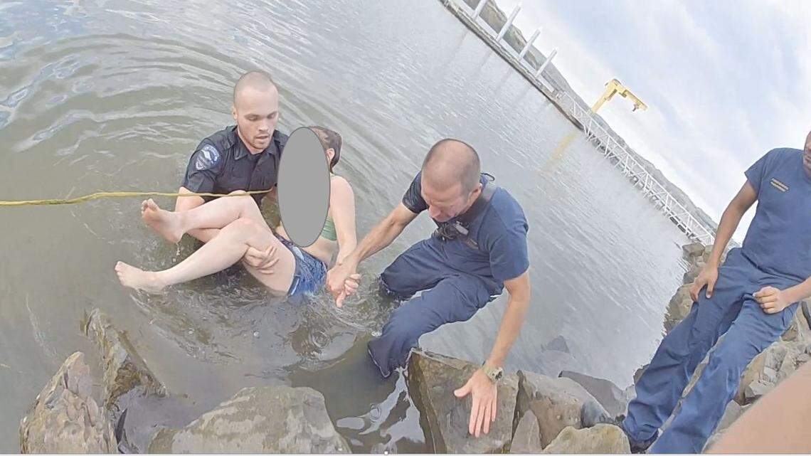 Police helped a woman who was stuck in the Columbia River for 30 minutes.