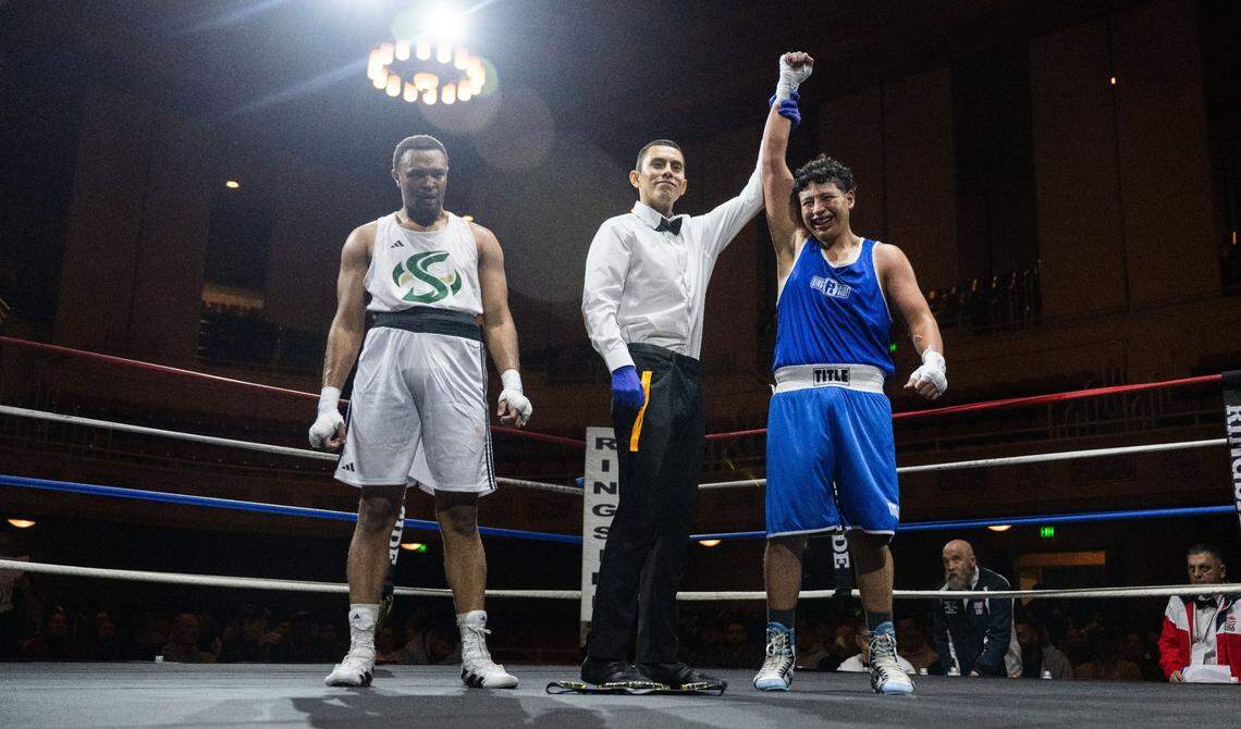 UC Davis’ Alejandro Silva is declared the winner after his fight against Corey Blackmon of Sacramento State during the Causeway Boxing Classic at Sacramento’s Memorial Auditorium on Friday.
