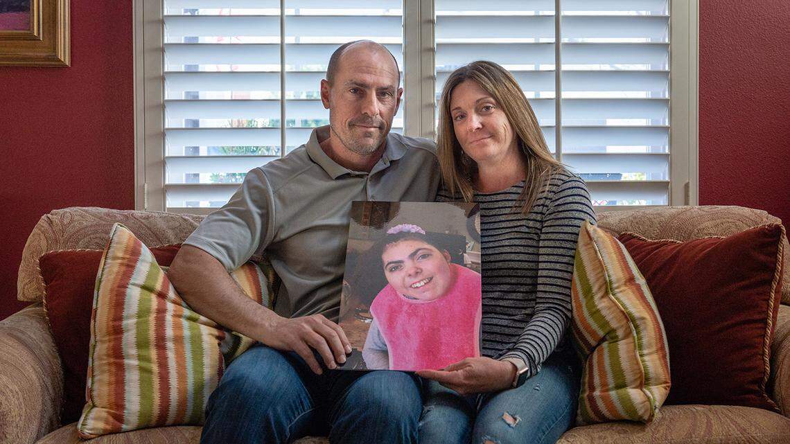 Bobby and Tara Dilliplaine hold a photo of daughter Brooke, who suffered complications when she was given medication she was allergic to. (She later died of causes unrelated to the EHR issue.)
