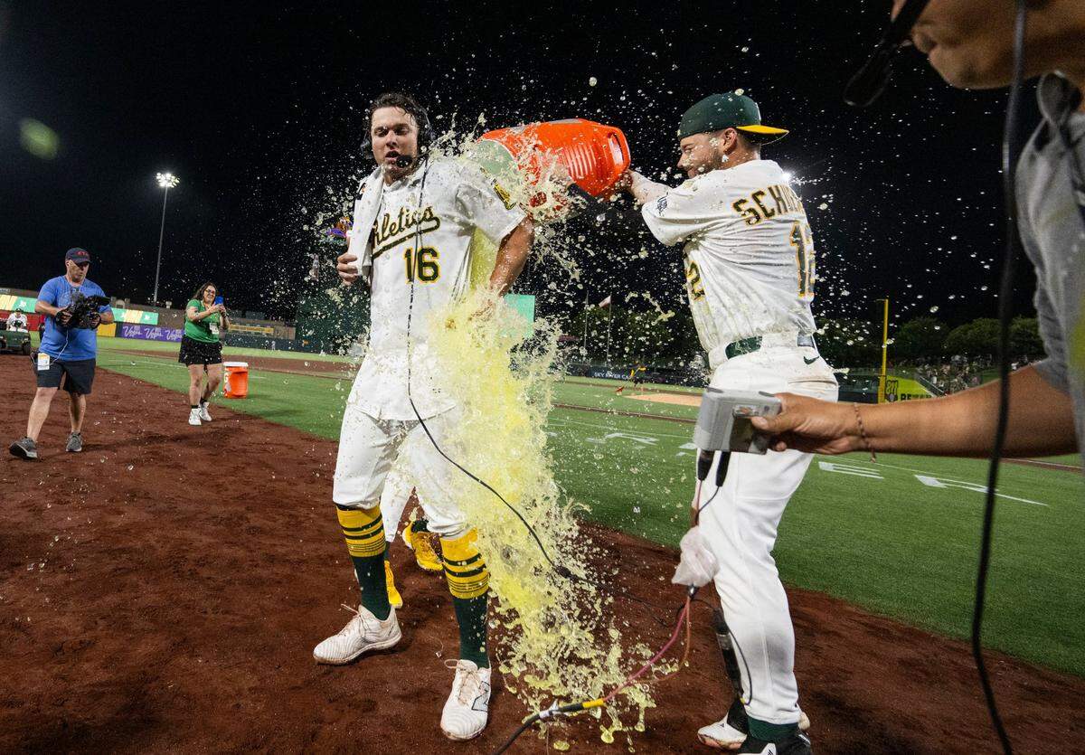 Athletics first baseman Nick Kurtz (16) is doused in Gatorade by third baseman Max Schuemann (12) after a two-run walk-off home run against the Houston Astros at Sutter Health Park on June 16.
