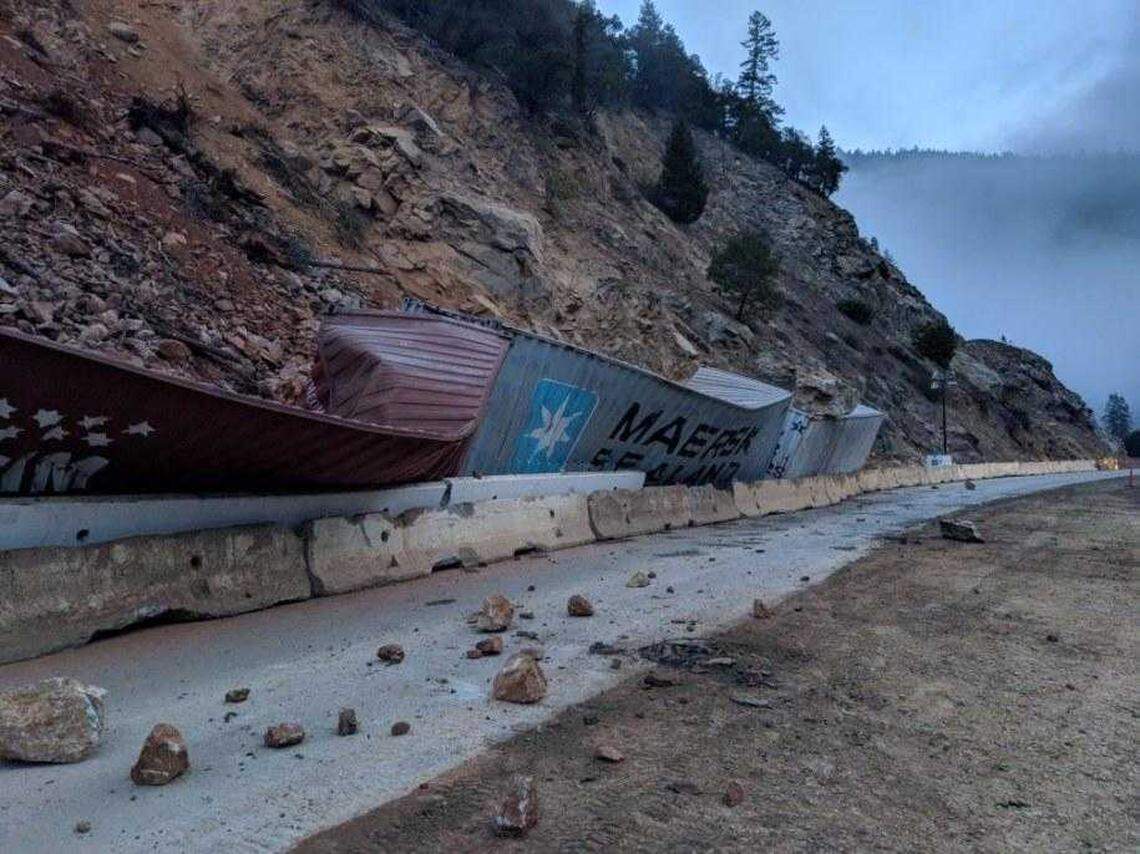 Cargo containers parked along the roadway on Highway 96 near the California-Oregon border are damaged by a rockslide Sunday, November 24, 2019. Motorists looking for holiday shortcuts should prepare for road damage and closures as the rainy season ramps up.