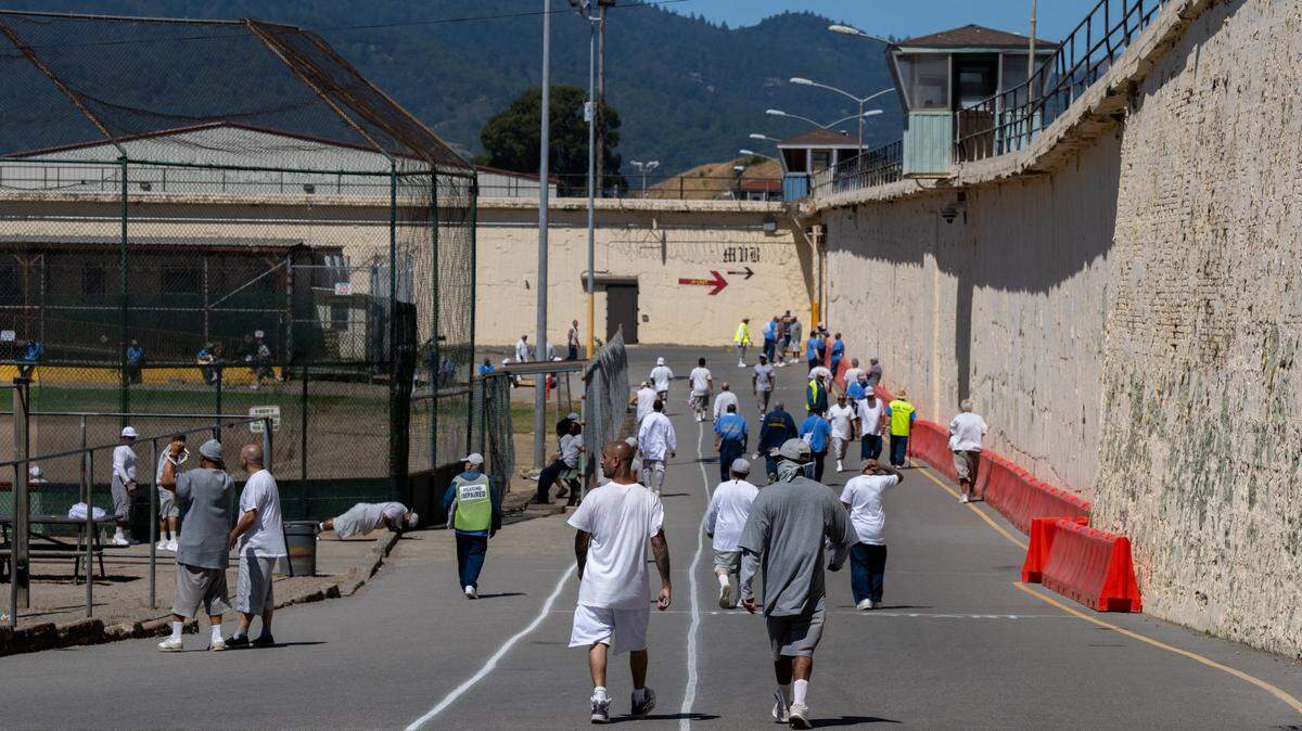 Inmates exercise outside in the yard at San Quentin State Prison on Wednesday, July 26, 2023. Gov. Gavin Newsom could close five prisons and save nearly $1 billion a year in California taxpayer money, the Legislative Analyst’s Office said.