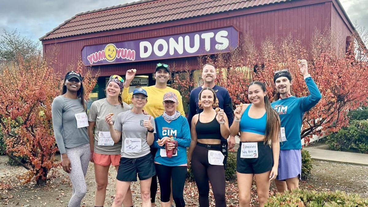 Runners participating in the 2024 Donut Half Marathon stop for a treat at Yum Yum Donuts, 3671 Franklin Blvd., in Sacramento. The free half-marathon fun run returns Saturday for its second year, stopping at nine doughnut shops and cafes around the city. 