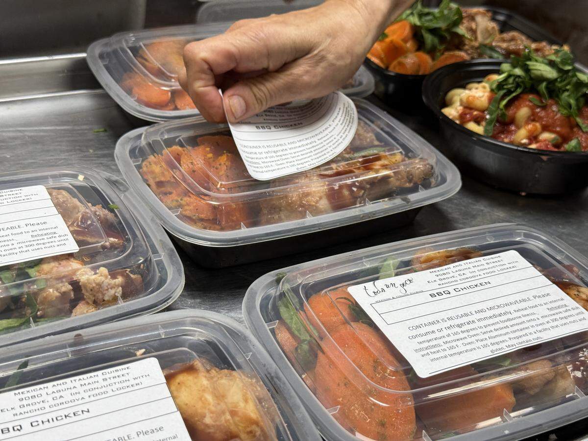 Prepared meals are labeled before being refrigerated and donated to the Rancho Gordo Food Bank on Saturday, March 21. Elk Grove restaurant Todo Un Poco makes the meals from donated foods as part of a pilot program to close the hunger gap.