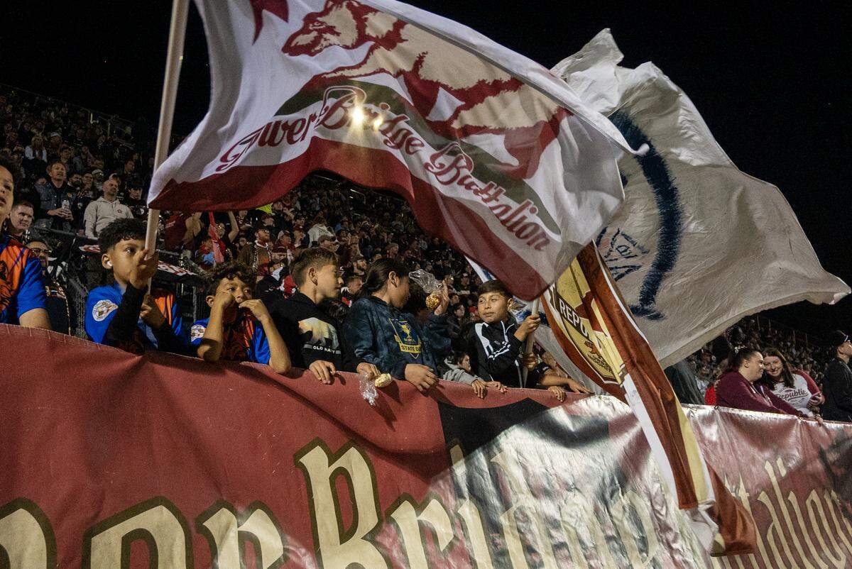 Kids wave the Tower Bridge Battalion flag during the Republic FC’s&nbsp;season-opening match against FC Tulsa on Saturday, March 7, at Heart Health Park in Sacramento.