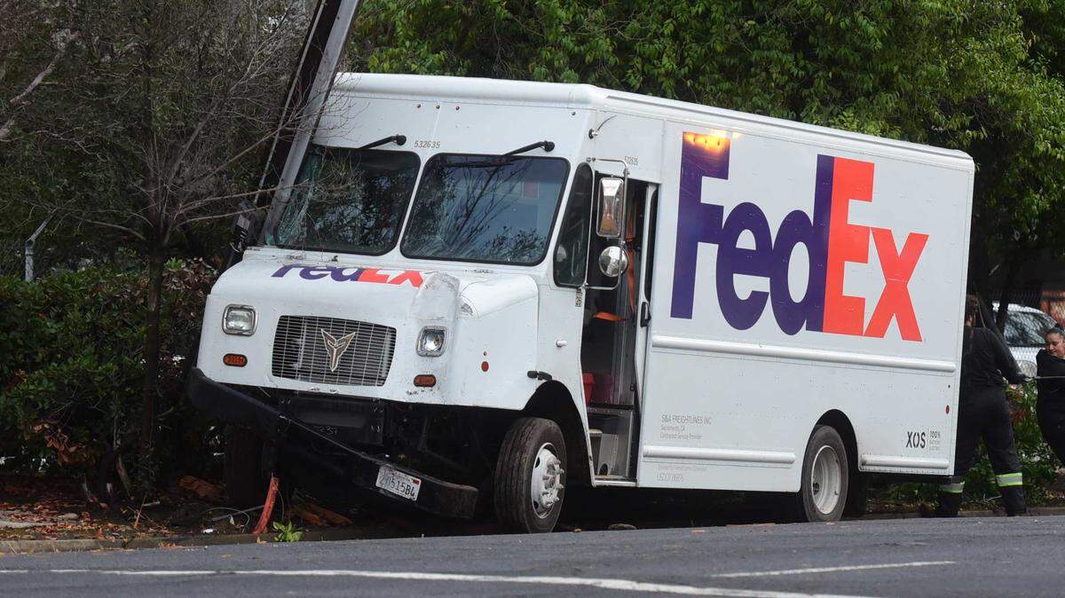 A FedEx delivery van is wedged against a utility pole on 29th Street in midtown Sacramento on Monday, Dec. 22, 2025. The vehicle was driving the wrong way on the one-way street before it crashed.