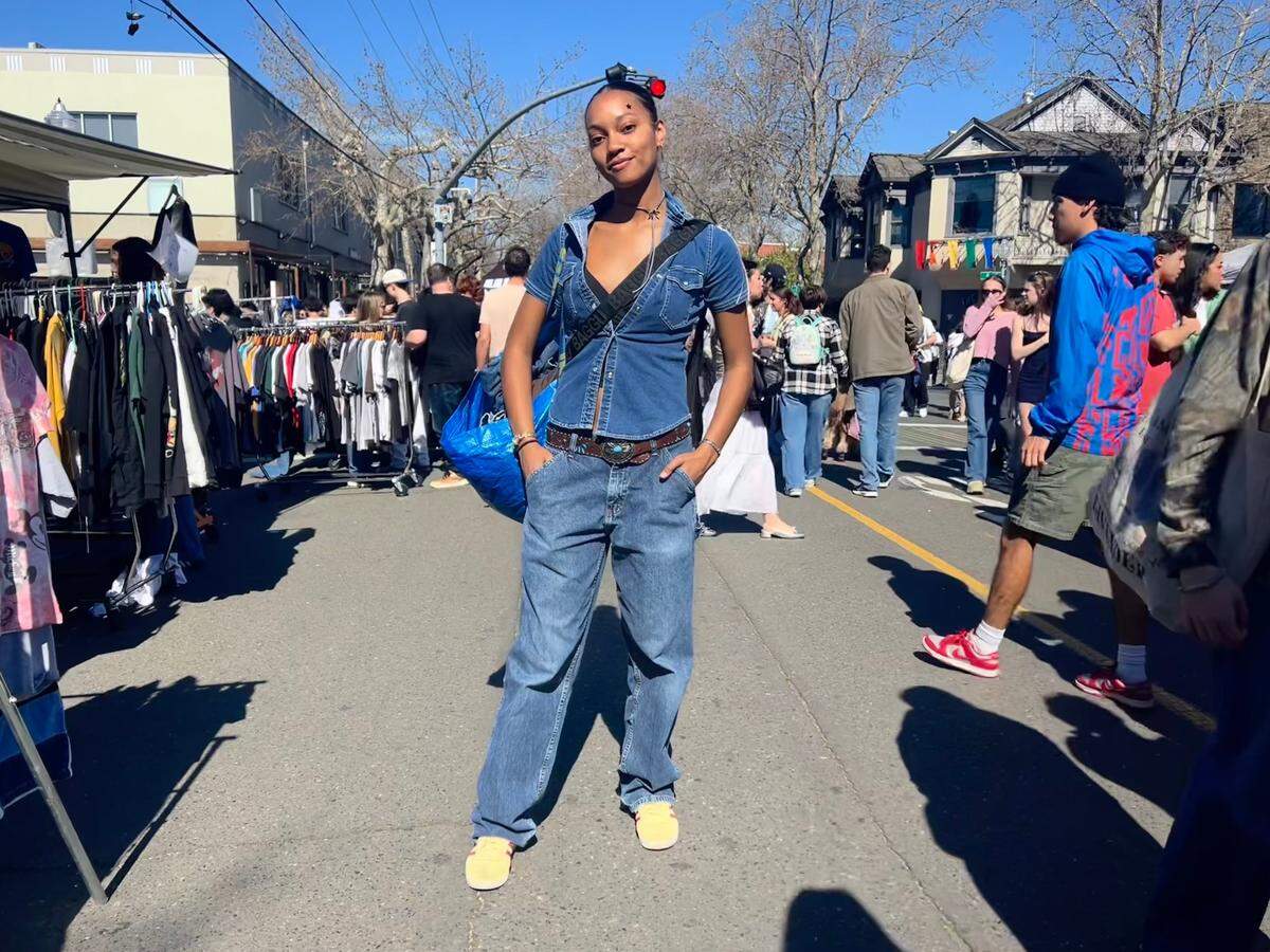 Jordyn Milan poses at World’s Worst Expo in midtown Sacramento. FIT CHECK: Milan is wearing thrifted Wrangler jeans, her sister’s belt, Adidas Gazelle shoes, a Baggu bag and an Ikea bag for all her items from the expo.