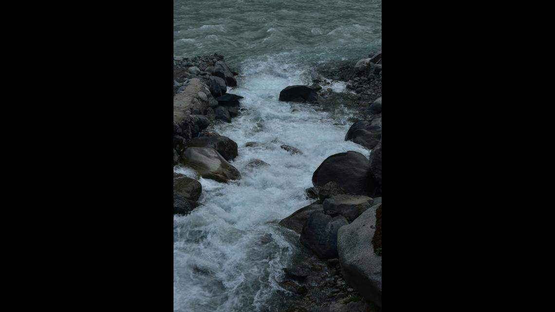 A woman swept down the rain-swollen Russian River near Guerneville fought two deputies who dove in to save her, California officials say.