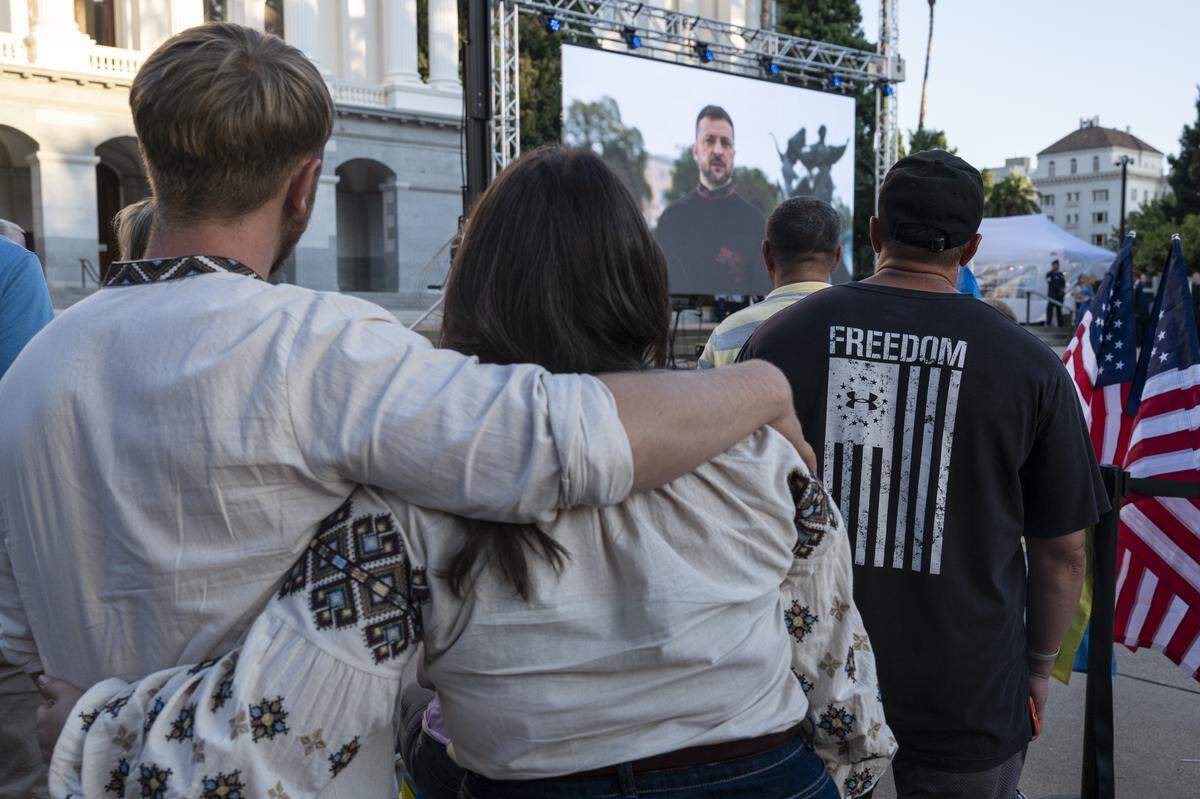 Ukrainian Americans react to a video message from Ukrainian President Volodymyr Zelenskyy during a Ukrainian Independence Day celebration at the California Capitol in Sacramento on Sunday.