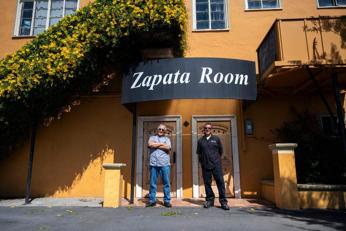 Brothers Ruben and Roy Unzueta, owners of Caballo Blanco restaurant, stand outside their event hall called the Zapata Room on Friday.