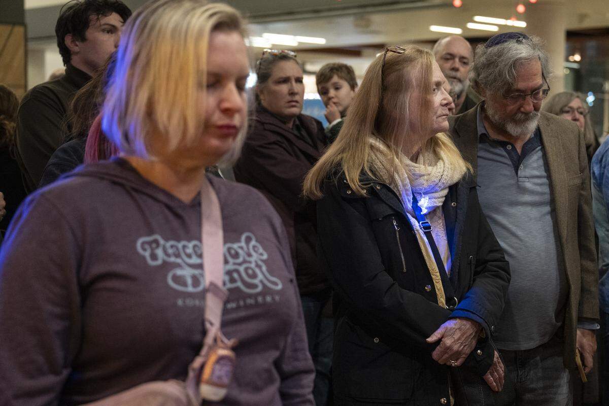 Members of the Roseville and Placer County Jewish community pray together during a menorah lighting on the first night of Hanukkah at the Westfield Galleria in Roseville on Sunday.