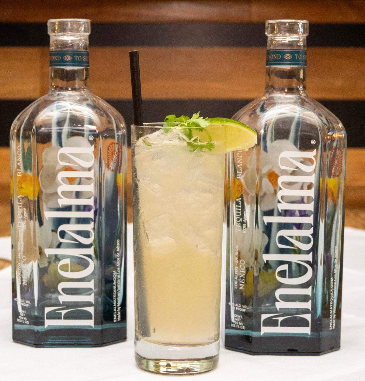 A drink made with Enelalma stands between two bottles of the local tequila before the second course of a dinner and tequila pairing event at Sienna in Roseville.