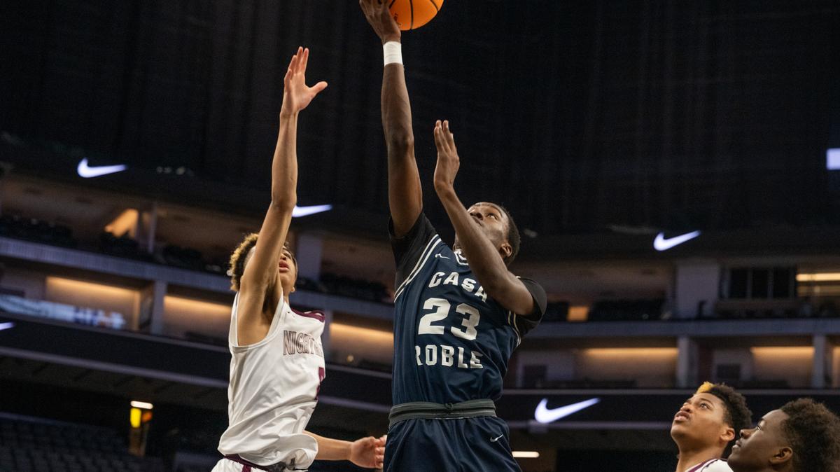 Casa Roble Rams forward Moses Oginni (23) makes a layup as Natomas Nighthawks guard Manno Jenkins (4) defends in the second half of the CIF Sac-Joaquin Section Division IV boys basketball championship at Golden 1 Center on Thursday.