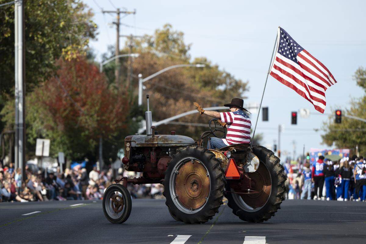 Tractors drive down East Bidwell Street during a Veterans Day parade in Folsom on Tuesday, Nov. 11, 2025.