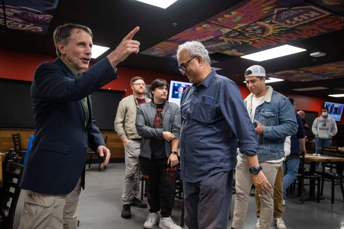 Dave Jones, left, gathers with his state Senate campaign supporters and staff, including volunteer Ravi Verma of Rocklin at right, at Rock & Brews at Cal Expo in Sacramento on Election Day late Tuesday, Nov. 8, 2022, to await the results of his race. Sacramento City Councilwoman Angelique Ashby ran against Jones for the District 8 seat.