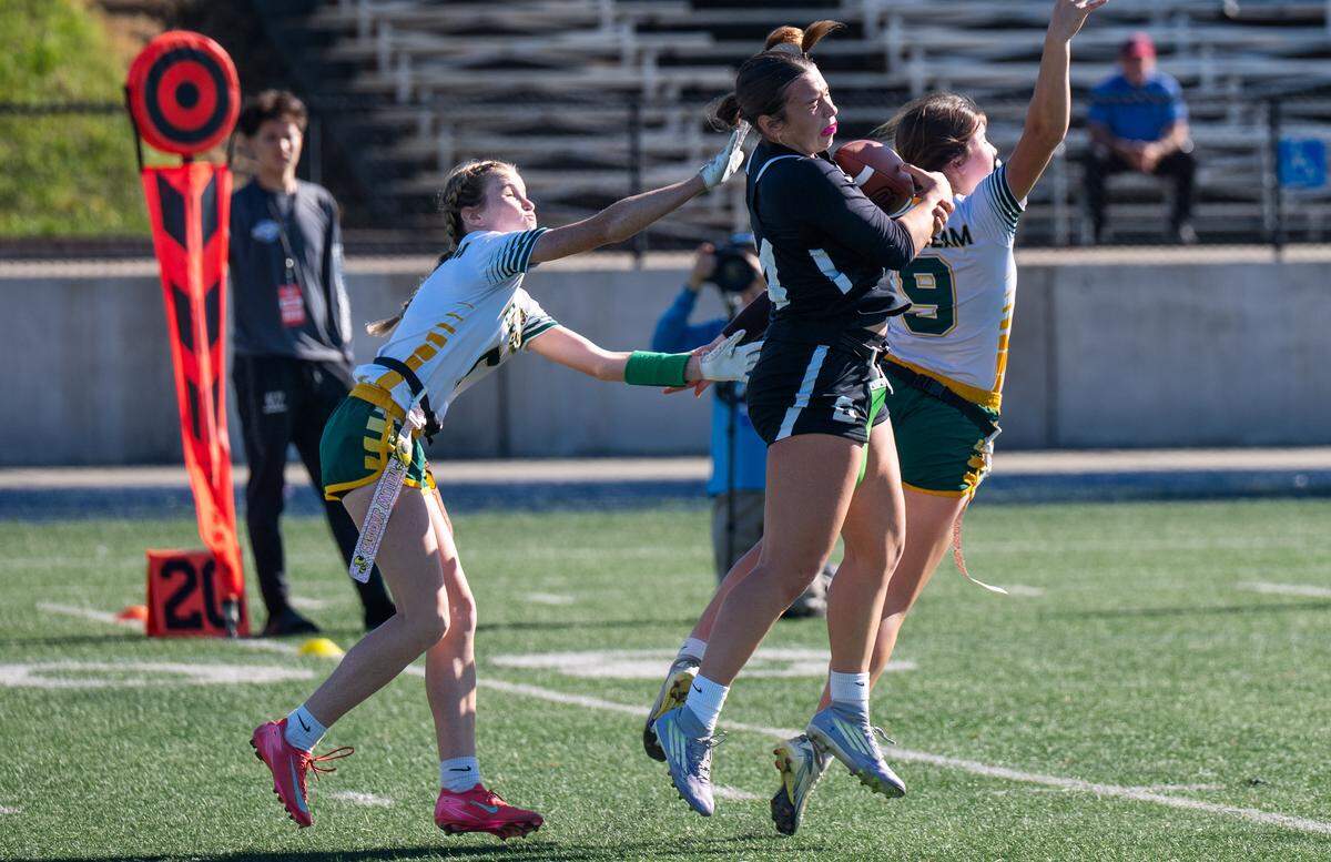 The Colfax Falcons' Maya Smiley (14) catches a pass before running for a 35-yard touchdown in the first half against the Hilmar Yellowjackets on Saturday. 