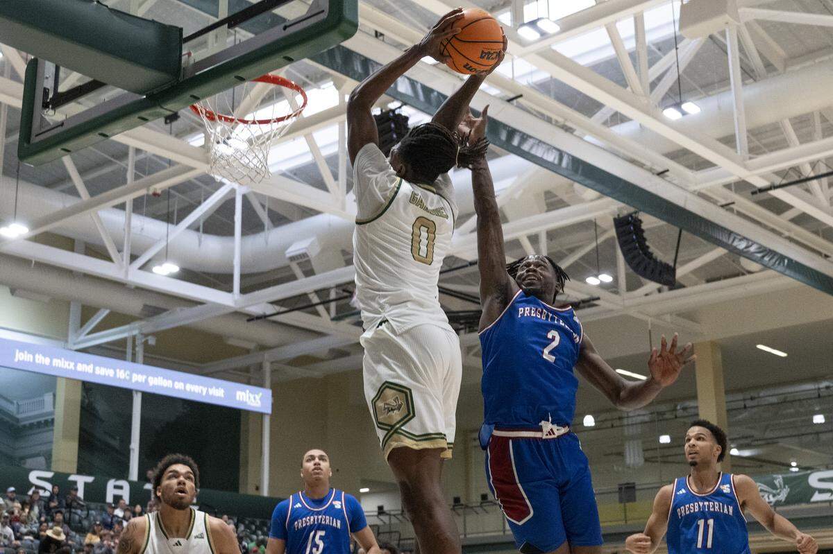 Sacramento State forward Brandon Gardner (0) dunks on Presbyterian guard Khalon Hudson (2) during a game between Sac State and Presbyterian at Hornet Pavilion in Sacramento on Sunday, Nov. 16, 2025.