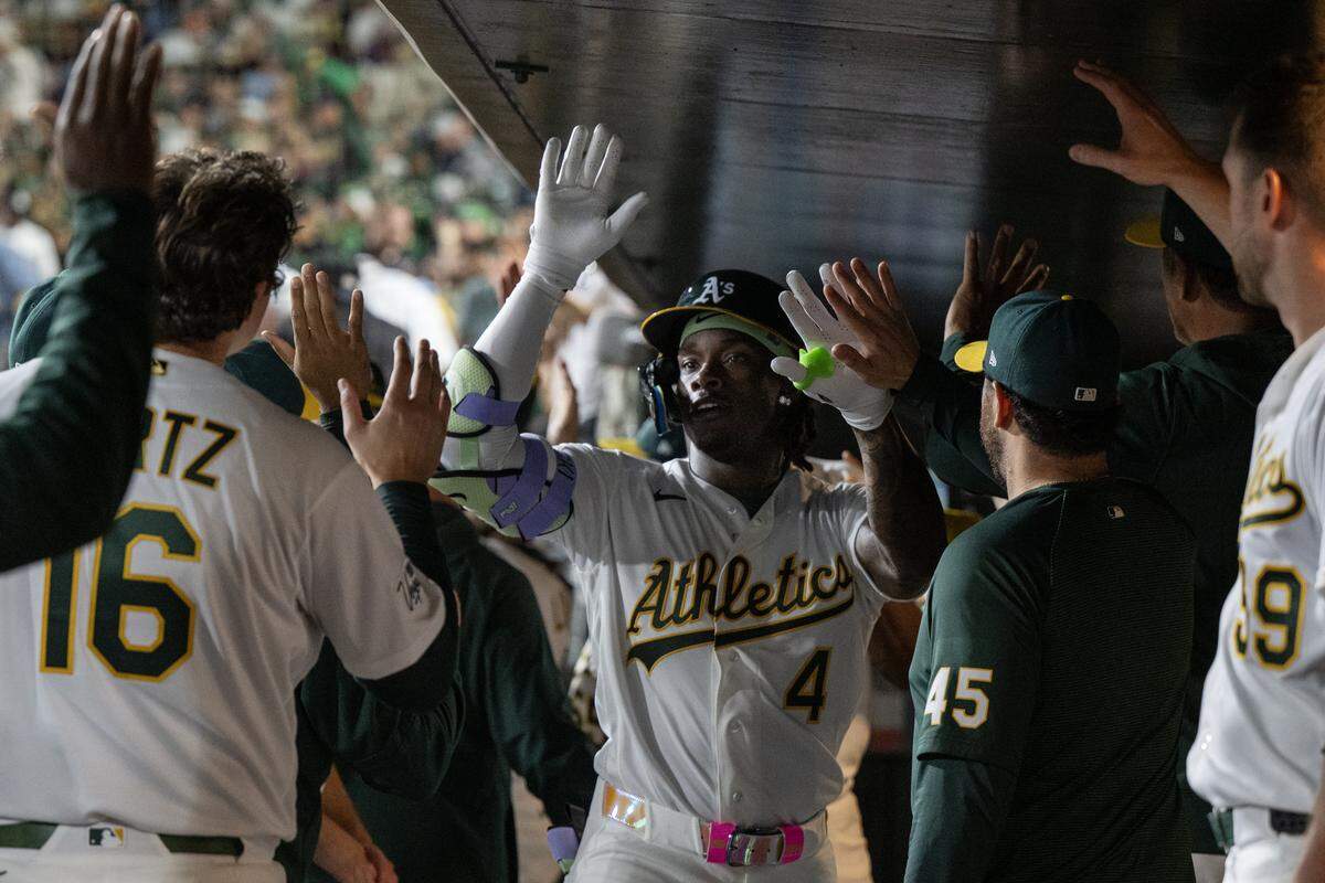 Athletics right fielder Lawrence Butler (4) is greeted by teammates after hitting a home run in the bottom of the fourth inning against the Houston Astros on Friday at Sutter Health Park in West Sacramento.