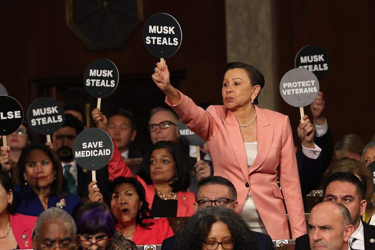 Mar 4, 2025; Washington, DC, USA; U.S. Rep. Nydia Velázquez (D-NY) holds a protest sign with fellow Democrats as U.S. President Donald Trump address a joint session of Congress at the U.S. Capitol on March 04, 2025 in Washington, DC. President Trump was expected to address Congress on his early achievements of his presidency and his upcoming legislative agenda. Mandatory Credit: Win McNamee-Pool via Imagn Images