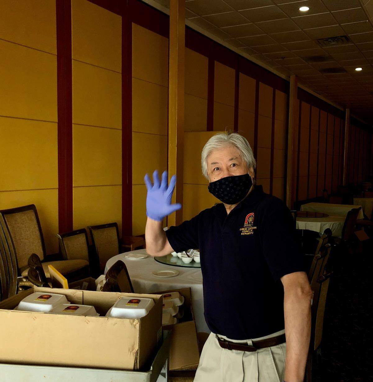 Alex Eng, president of the CACS Council, gets ready to roll out a carton of boxed lunches to organizers waiting outside.