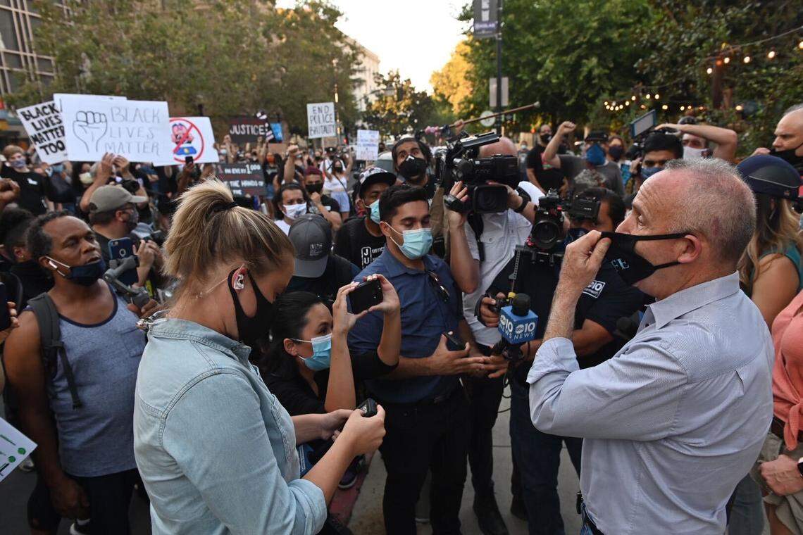 Mayor Darrell Steinberg is surrounded by protesters outside La Cosecha at Cesar E. Chavez Plaza, as news media watches as a rally turned into a march Thursday, Aug. 27, 2020, in downtown Sacramento. It was the first of two planned protests organized by separate groups over the police shooting of Jacob Blake in Wisconsin.