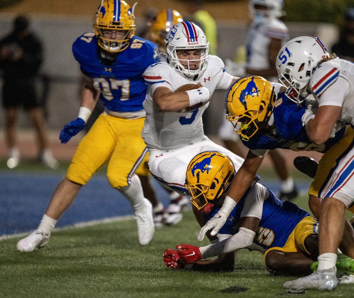 Folsom Bulldogs' quarterback Ryder Lyons (3) scores a touchdown in the first half against the Grant Pacers on Saturday in Del Paso Heights.