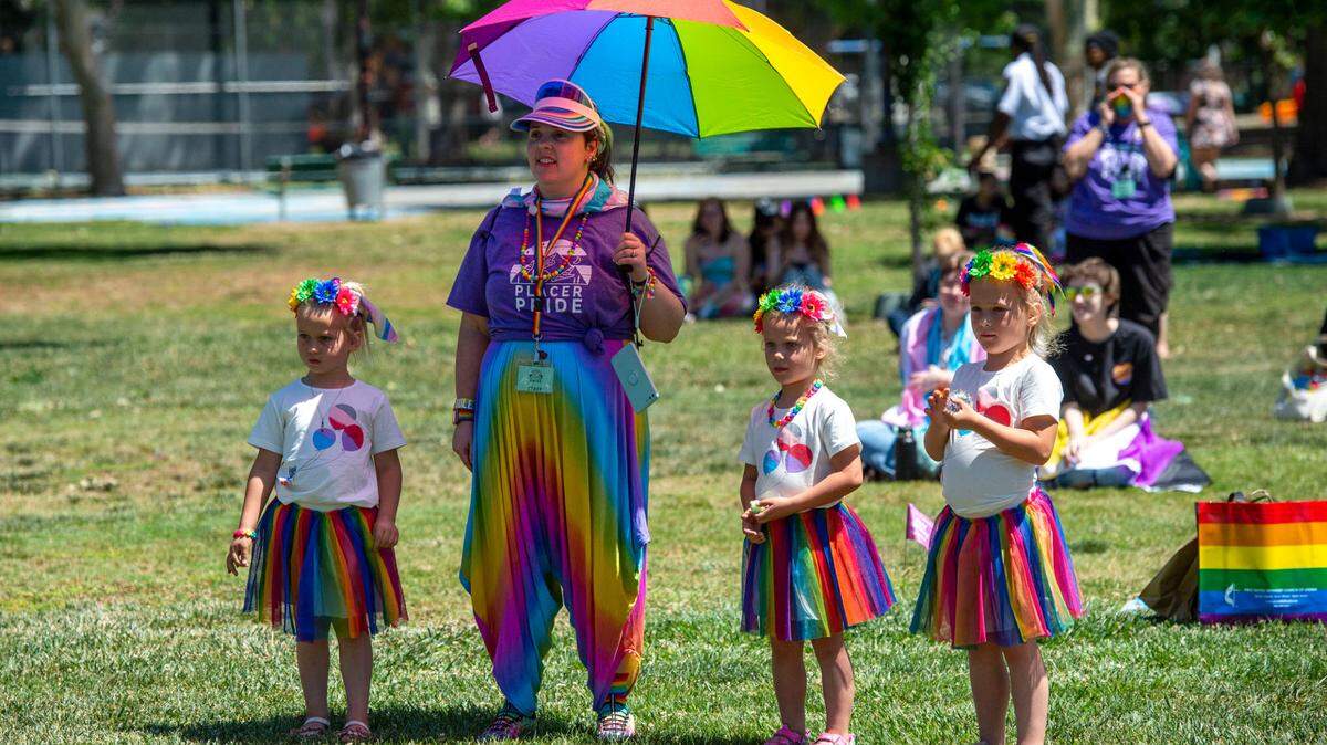 Staff memeber Jacque Vaughn and neices Ellie, Sophie and Natalie Latteri came all decked out in rainbow colors as they watch performers dance on the Royer Park gazebo stage during Placer Pride on May 21, 2022.