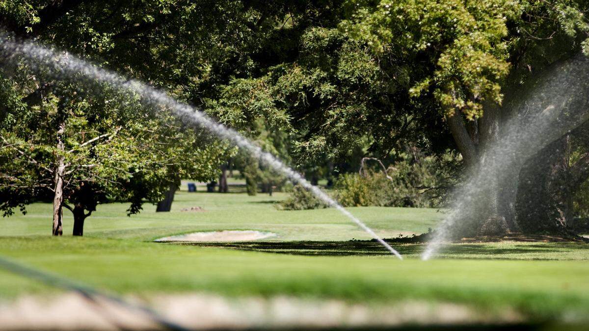 Sprinklers water the William Land Park golf course.