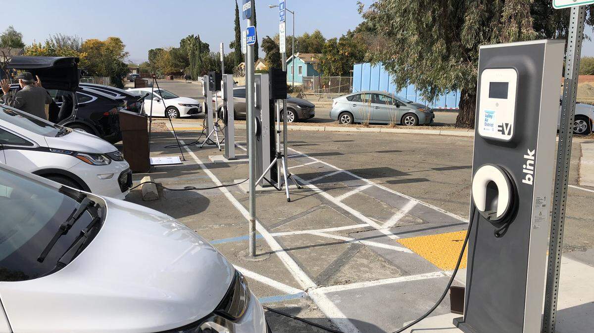Four electric vehicles - two Chevy Bolts and two Teslas - charge in the community of Cantua Creek on Nov. 15, 2019. Sacramento County offers free electric vehicle charging in their parking lots.