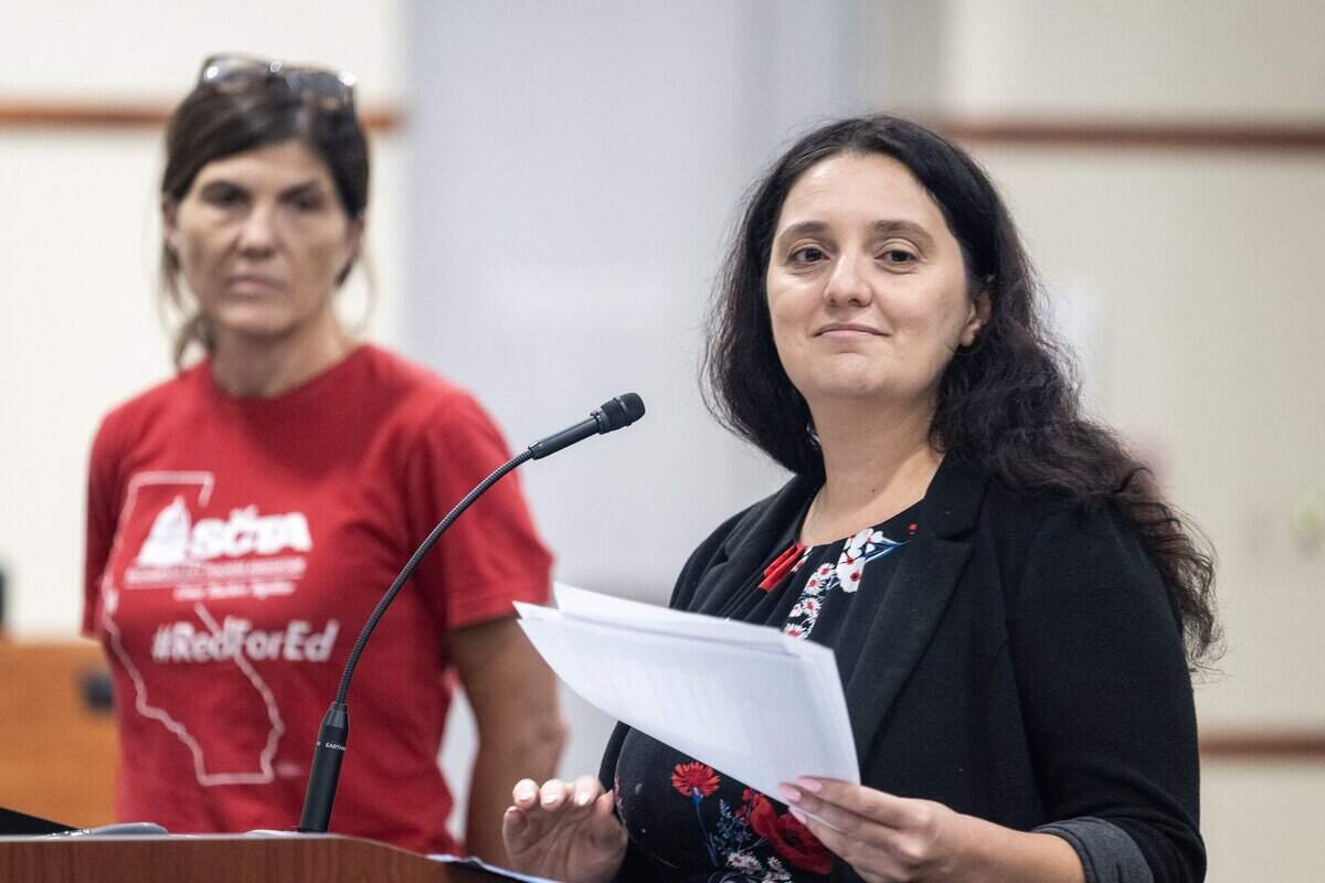 Sacramento City Teachers Association Second Vice President Vanessa Cudabac, right, with Nikki Milevsky, president of the association, speaks about ongoing contract negotiations with St. Hope Charter School to the Sacramento City Unified School District board meeting on Thursday.