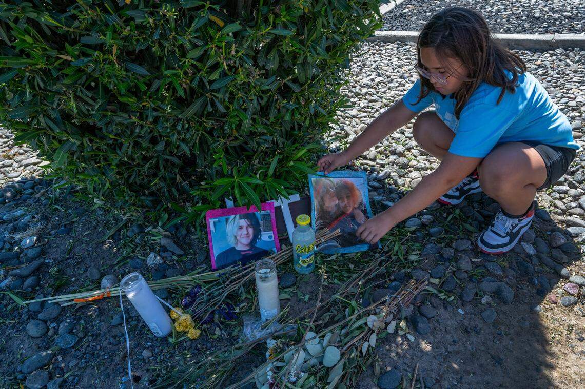 Shawn Jordan’s sister Lennox, 10, straightens out a picture of her brother and his boyfriend at a memorial at the corner of Walerga Road and Kirkby Way on June 26. Her father Seth Jordan said that when he picked up Lennox from school she wanted to go visit her brother’s memorial. On June 15, before sunset, Shawn was hit by a car while walking home, according to the California Highway Patrol. “He was just a few blocks away from home,” Seth said.