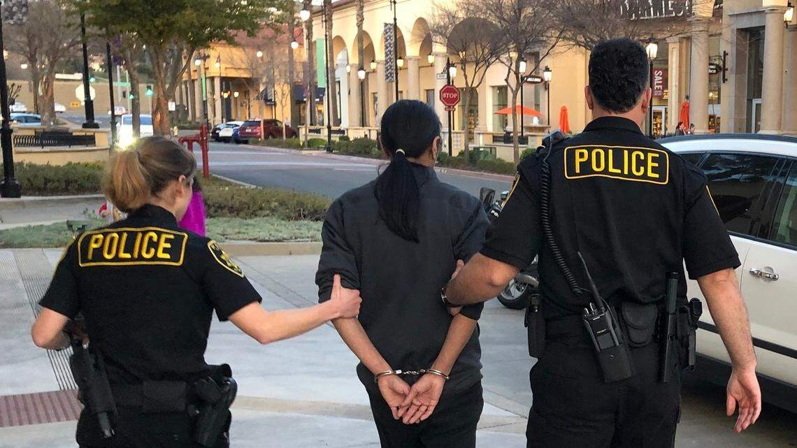 Tomas Green, 47, of Folsom is escorted by Department of Alcoholic Beverage Control agents from the Blue Nami sushi restaurant in Folsom’s Palladio outdoor mall in handcuffs.