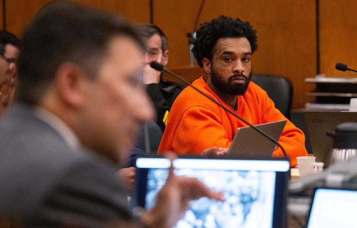 Murder suspect Mtula Payton, center, listens to prosecutor Brad Ng, left, question a cousin of victim Sergio Harris during a preliminary hearing in Sacramento Superior Court on Tuesday, April 4, 2024, in the case of the April 2022 mass shooting in downtown Sacramento.