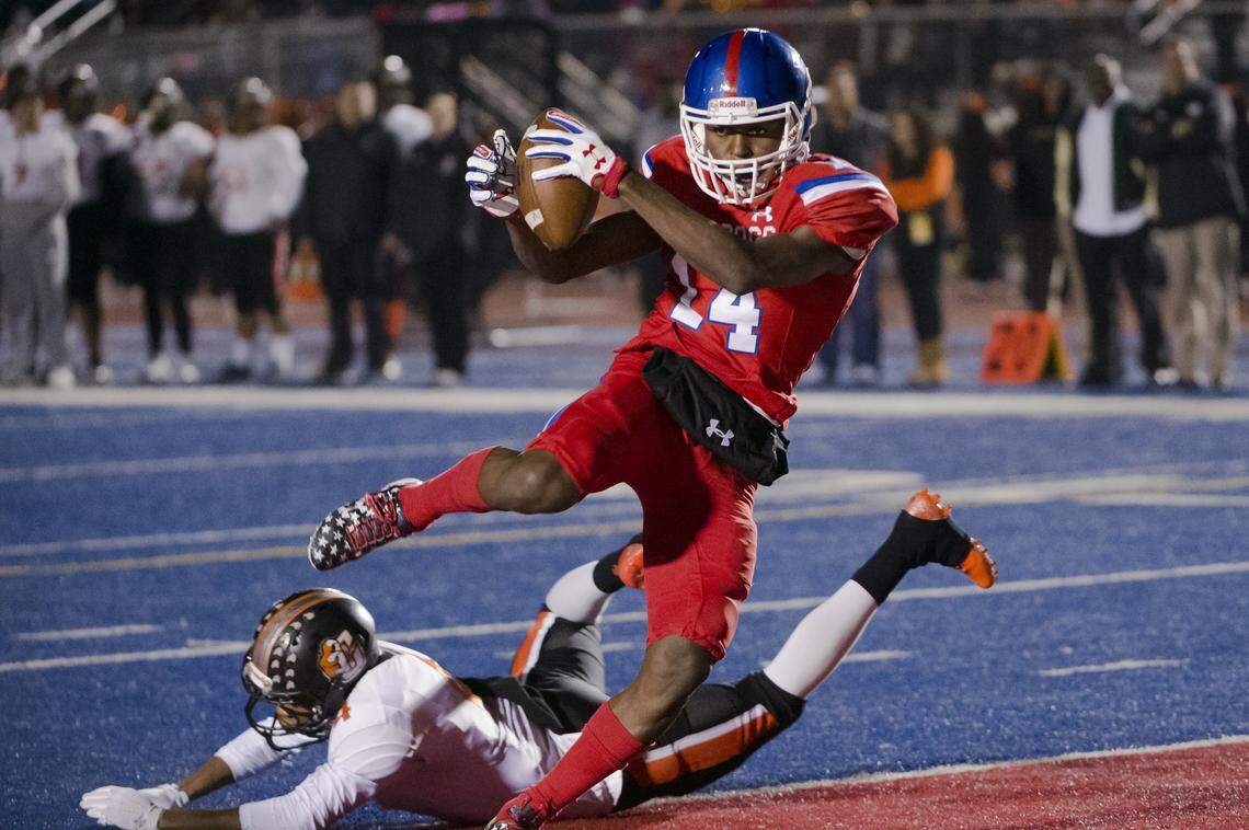 Same time this year: Folsom’s Elijhah Badger is pictured avoiding a Central defender as he scores on a 9-yard touchdown catch in the CIF NorCal Division I-AA title game on Dec. 8, 2017. On Friday night, almost a year to the day later, Badger had three touchdown receptions and a 72-yard kickoff return as the Bulldogs ran off to an 84-46 victory over Central in Fresno to earn another berth in a CIF state bowl game.