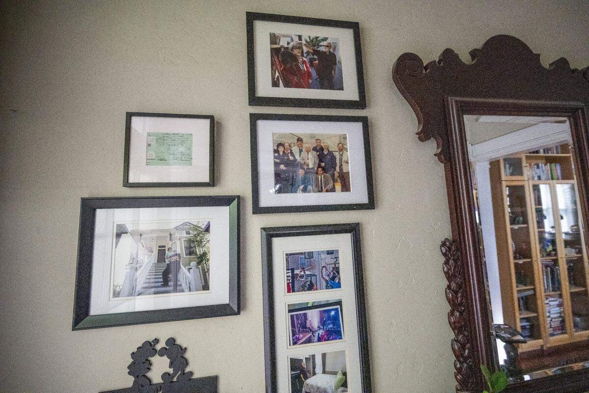 A collection of photos, showing the investigators that found the bodies of the victims of serial killer Dorothea Puente, hangs on the wall.