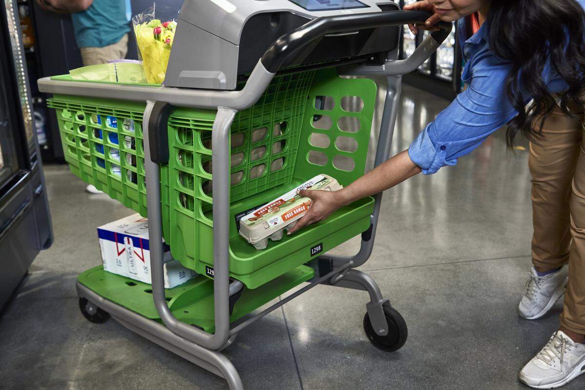 An Amazon Fresh customer adds a cartoon of eggs to her Amazon Dash Cart.