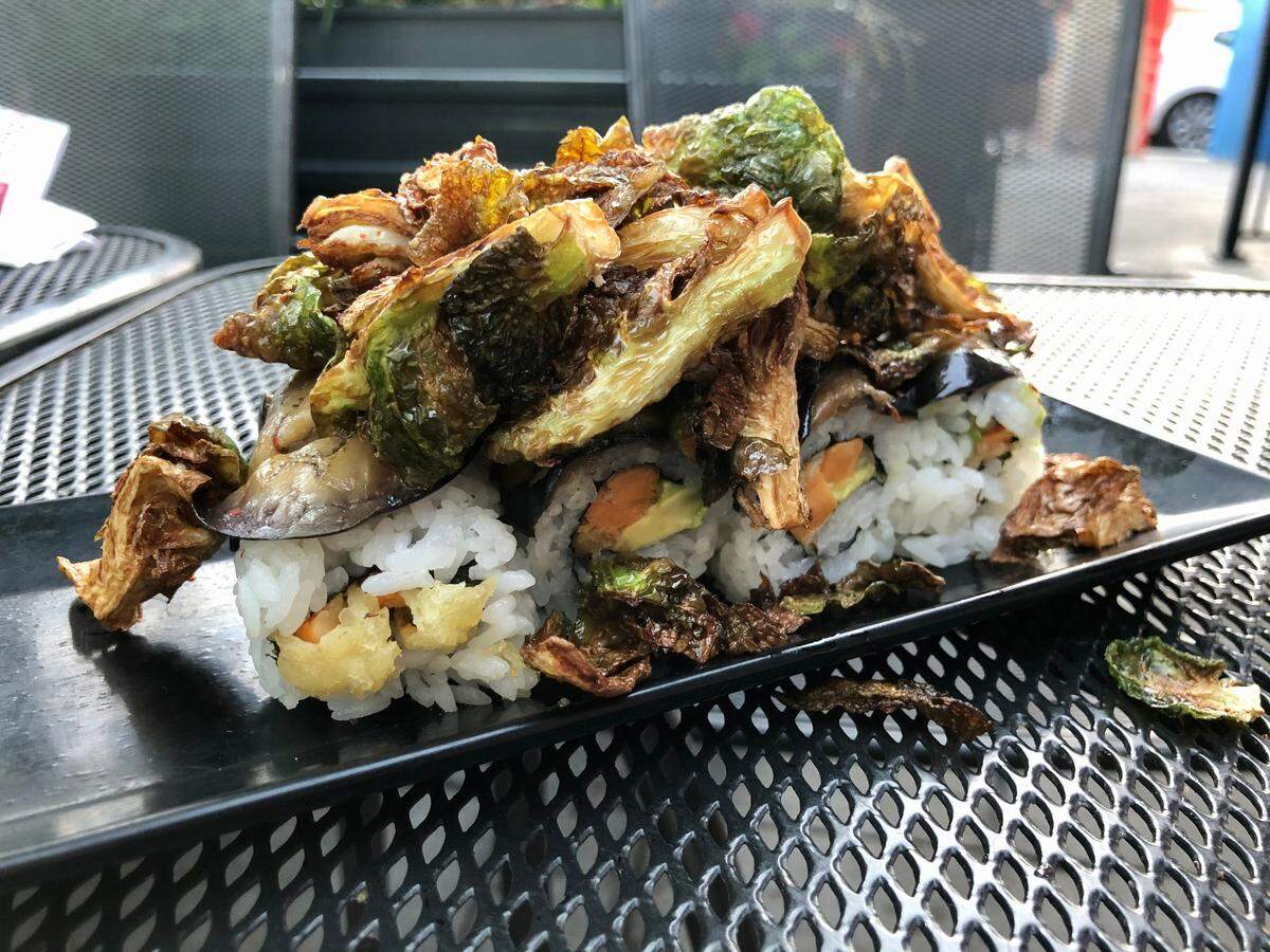 Midtown Sushi’s vegan Irishman roll comes with sweet potato, avocado, marinated eggplant and blackened Brussels sprouts.
