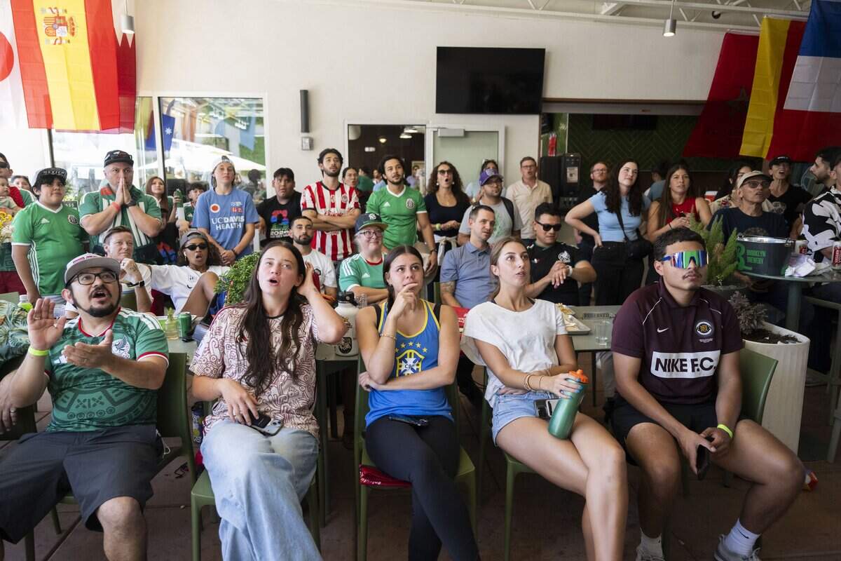 World Cup soccer fans react to a red card on Mexico’s César Montes during a watch party at Garden at the Line in Sacramento on Thursday.