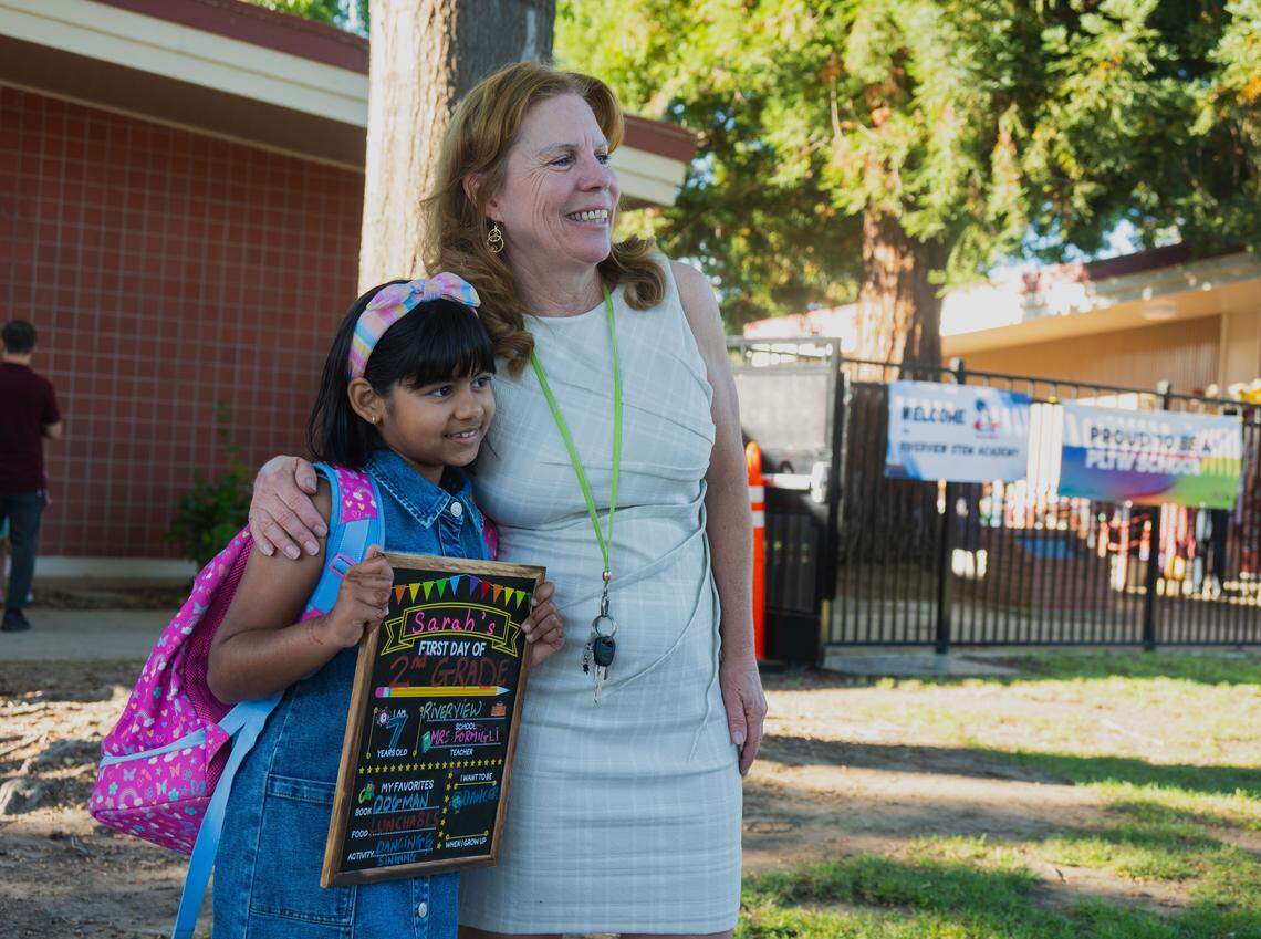 Principal Lari Powell poses for a picture with second grader Sarah Tinmaker, 7, on the first day of school at Riverview STEM Academy on Thursday, Aug. 7, 2025.