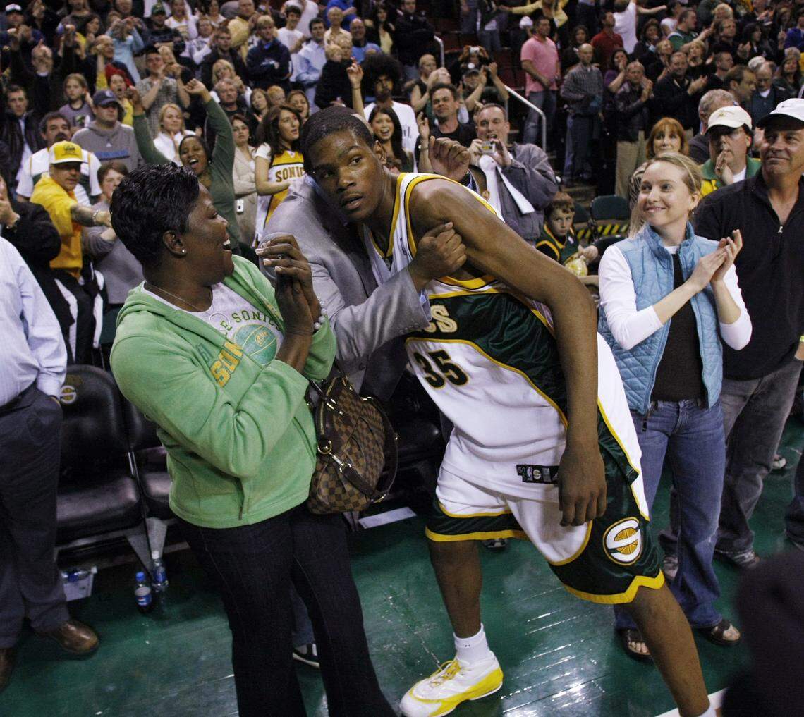 Seattle SuperSonics’ Kevin Durant receives a hug while his mother Wanda Pratt watches on the left after the 99-95 win over the Dallas Mavericks in Seattle, April 13, 2008. It was the Sonics’ last home game.