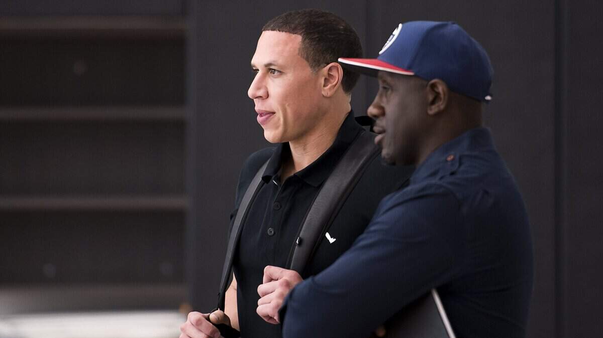 FILE -- Former Kings Mike Bibby and Bobby Jackson watch the Sacramento Kings practice at Golden 1 Center on Sept. 27, 2016.