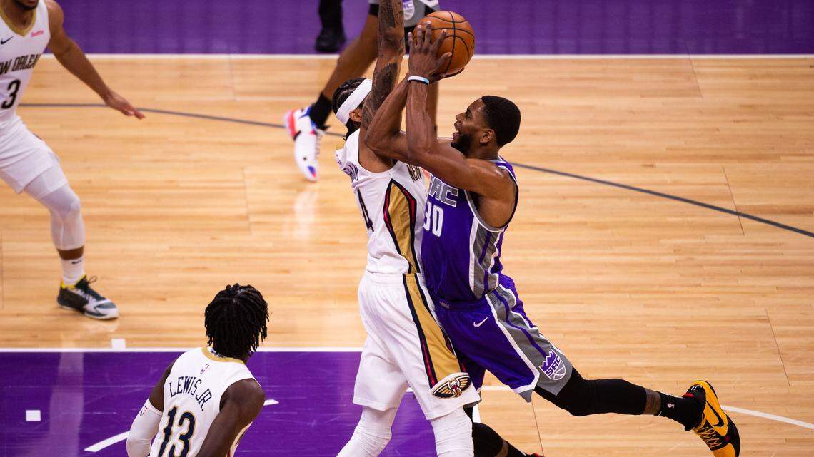 Sacramento Kings forward Glenn Robinson III (30), right, is fouled by New Orleans Pelicans forward Brandon Ingram (14) during the first half of the NBA game Sunday, Jan. 17, 2021, at Golden 1 Center in Sacramento.