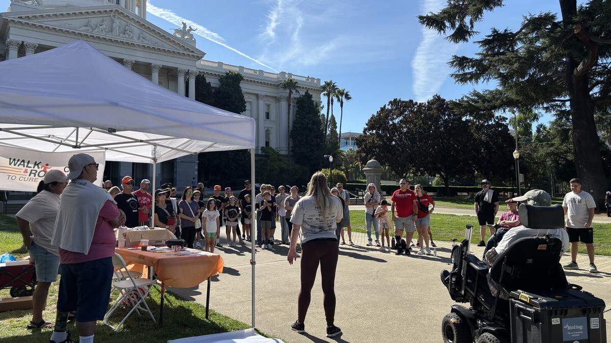 Brittany Lauro, 29, speaks to attendees at the second annual Walk & Roll event of the FSHD Society’s Sacramento chapter on September 7, 2025. Lauro was diagnosed with the muscular degenerative disease when she was 14.
