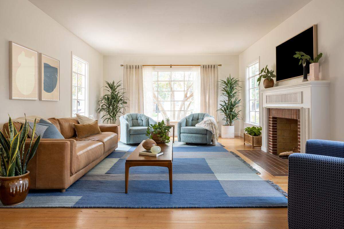 Kele Dobrinski and Christina Valencia show off the finished living room of a Land Park bungalow designed for the “Bright Harmony” episode of their HGTV show “Mash-Up Our Home.”